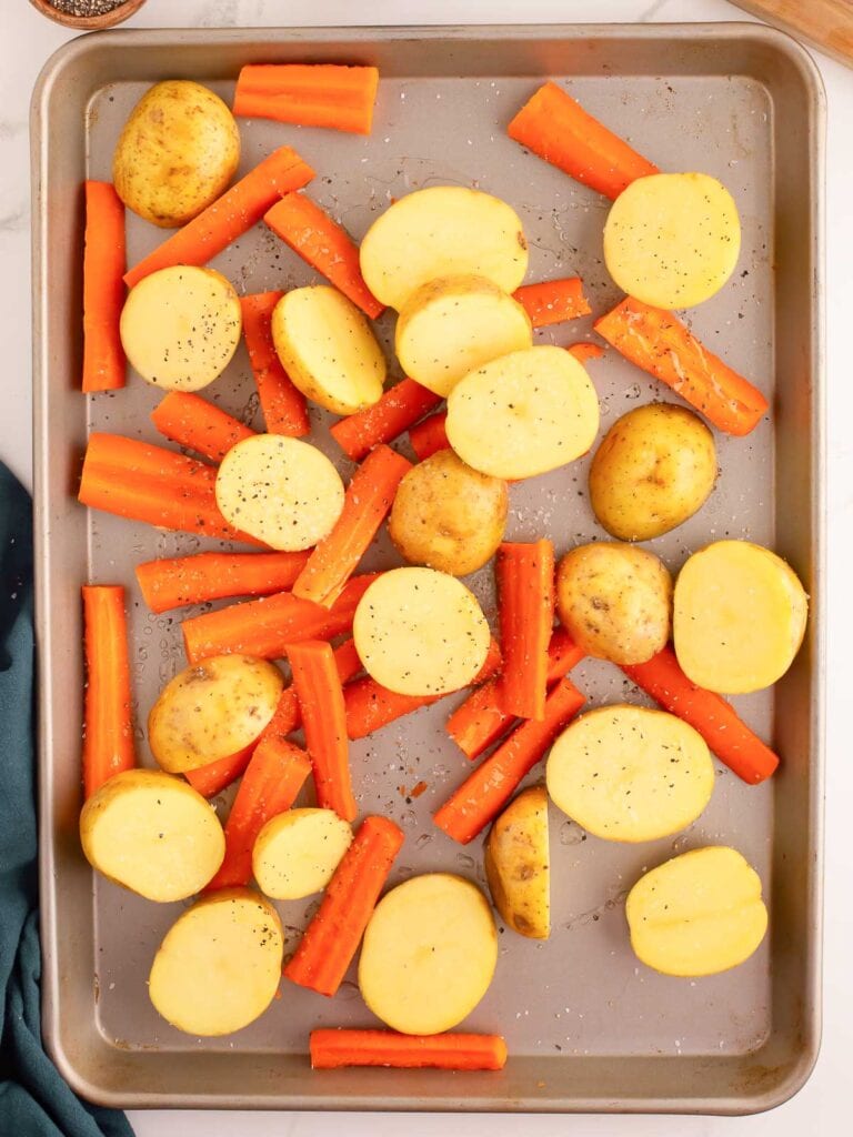 Carrots and potatoes on a baling tray before they get roasted.