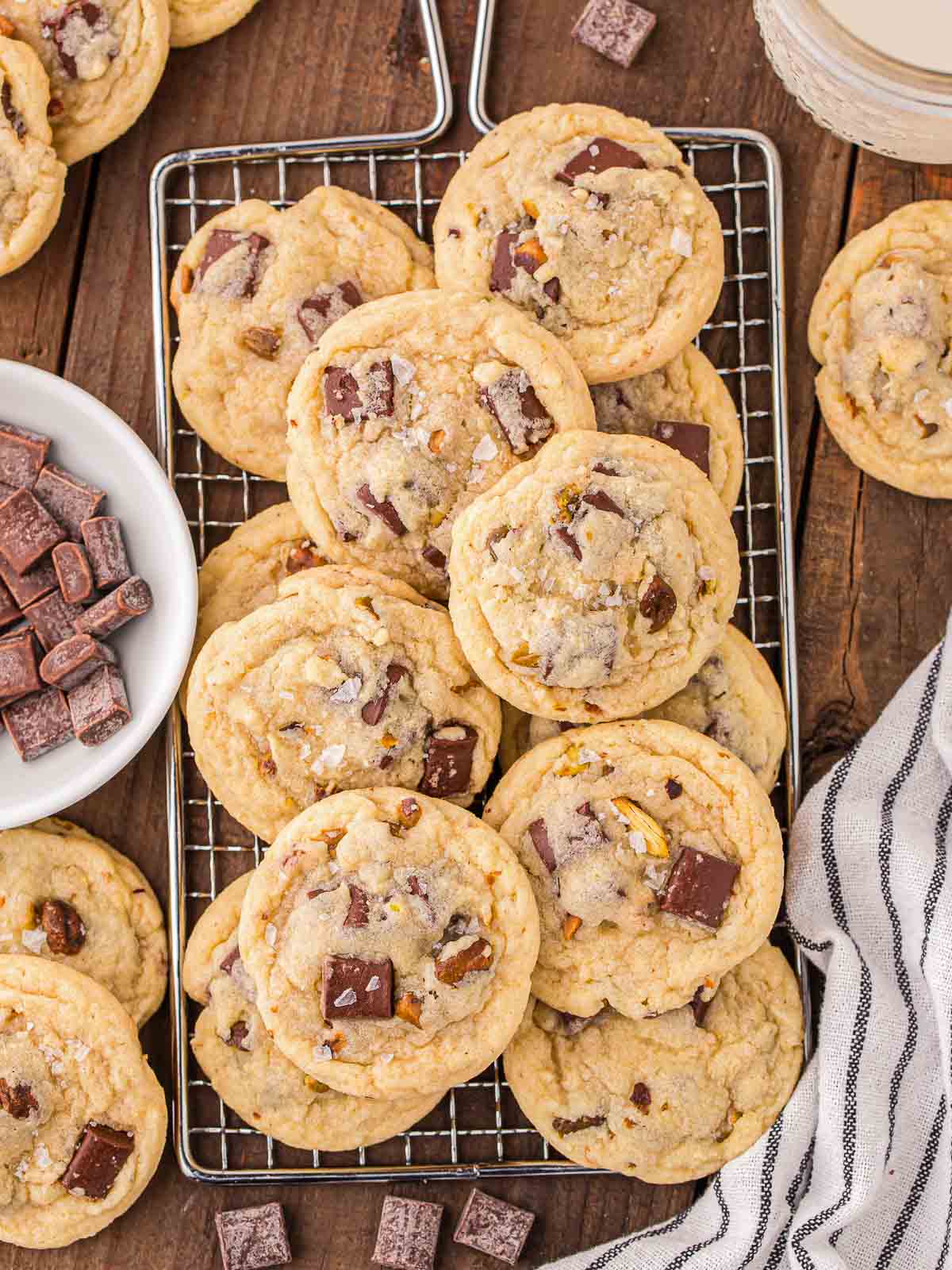 Pistachio Cookies on a wire rack on a wooden table.