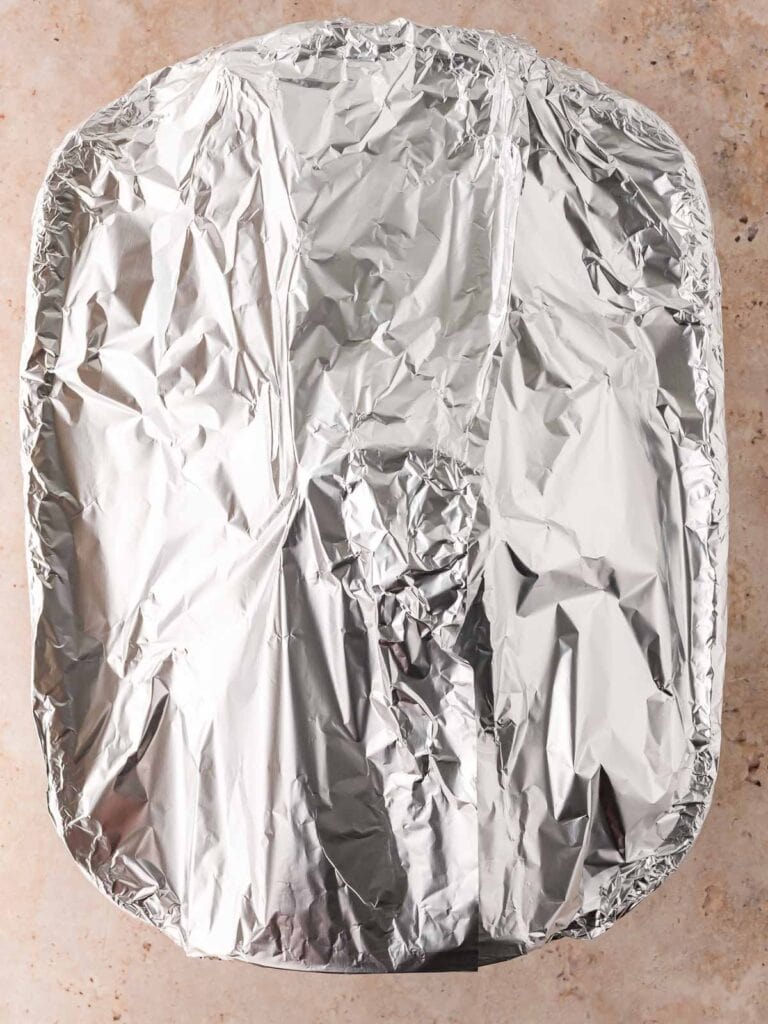 The roasting tray covered in foil.