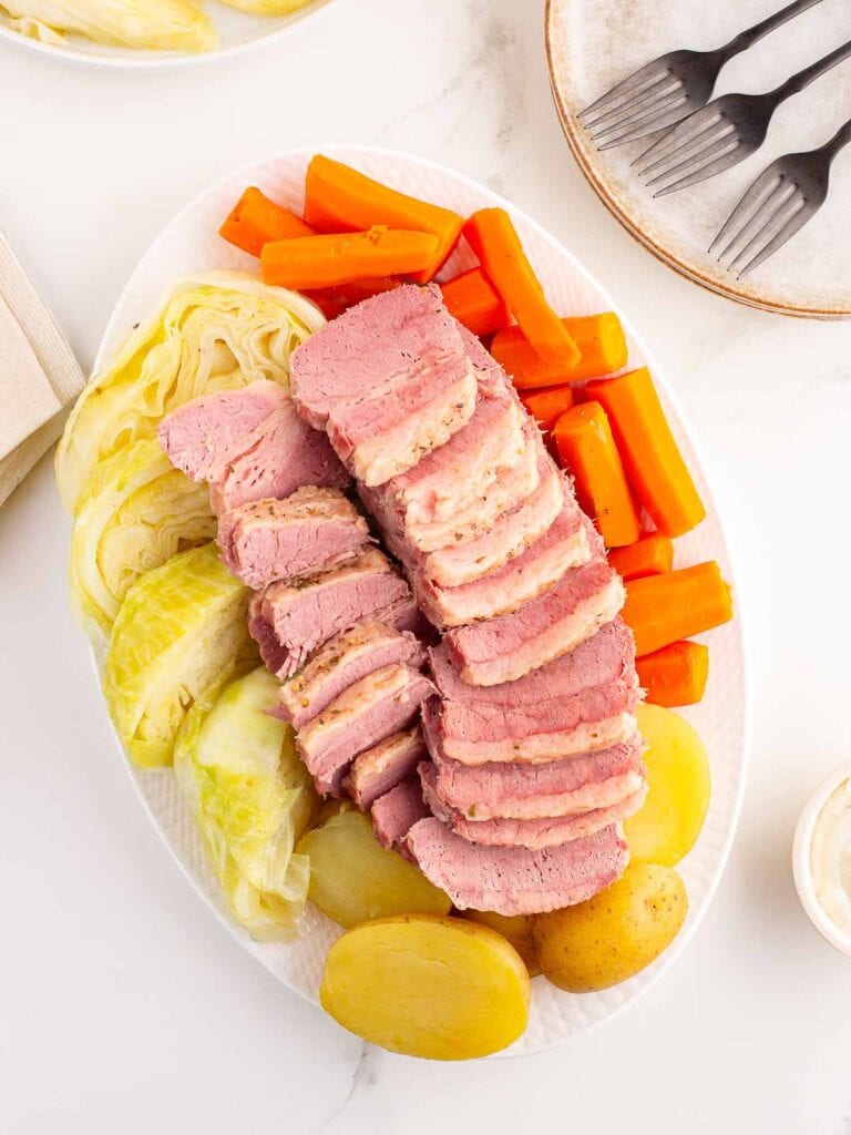 Corned Beef and Cabbage, along with carrots and potaoes on a serving plate.