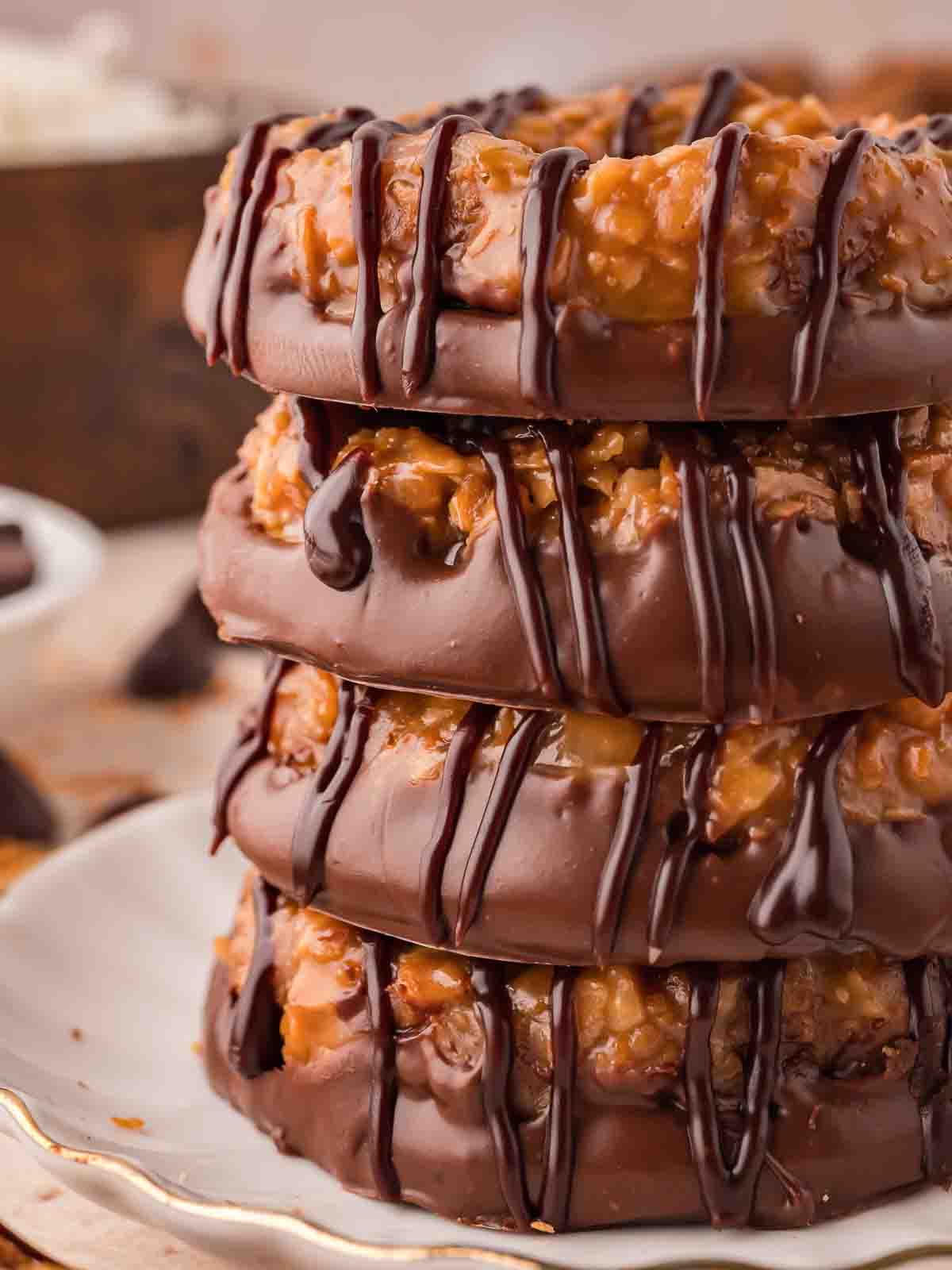 A stack of Samoas Cookies with choaolate drizzle.