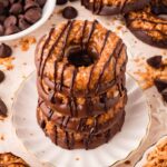 A 45 degree of a stack of Samoas Cookies on a plate.