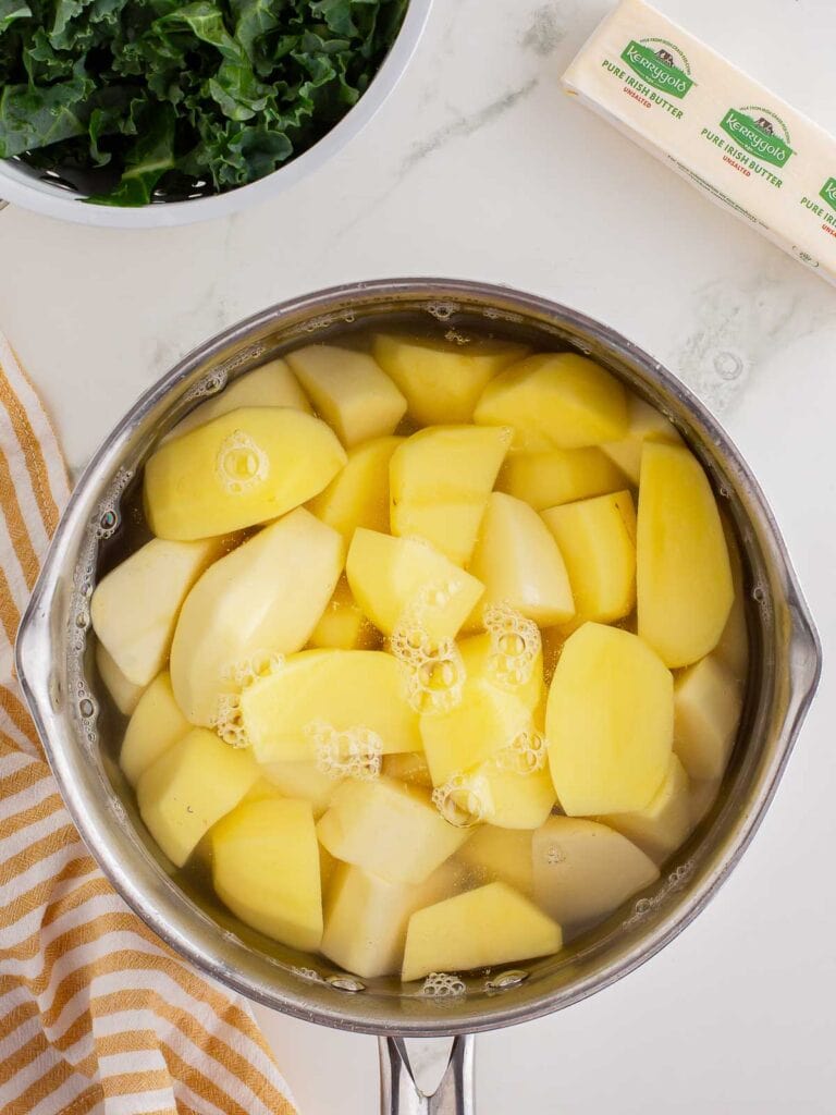 Raw potatoes in a pot of water.