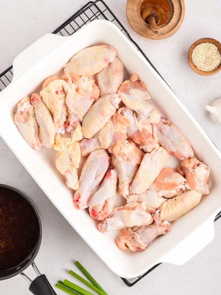 Raw Chicken wings in a casserole dish.