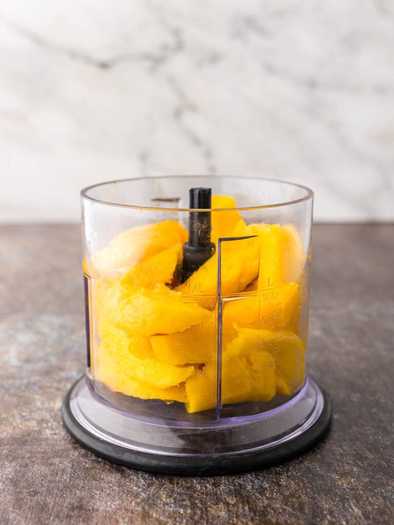 Chopped Mango in a food blender.