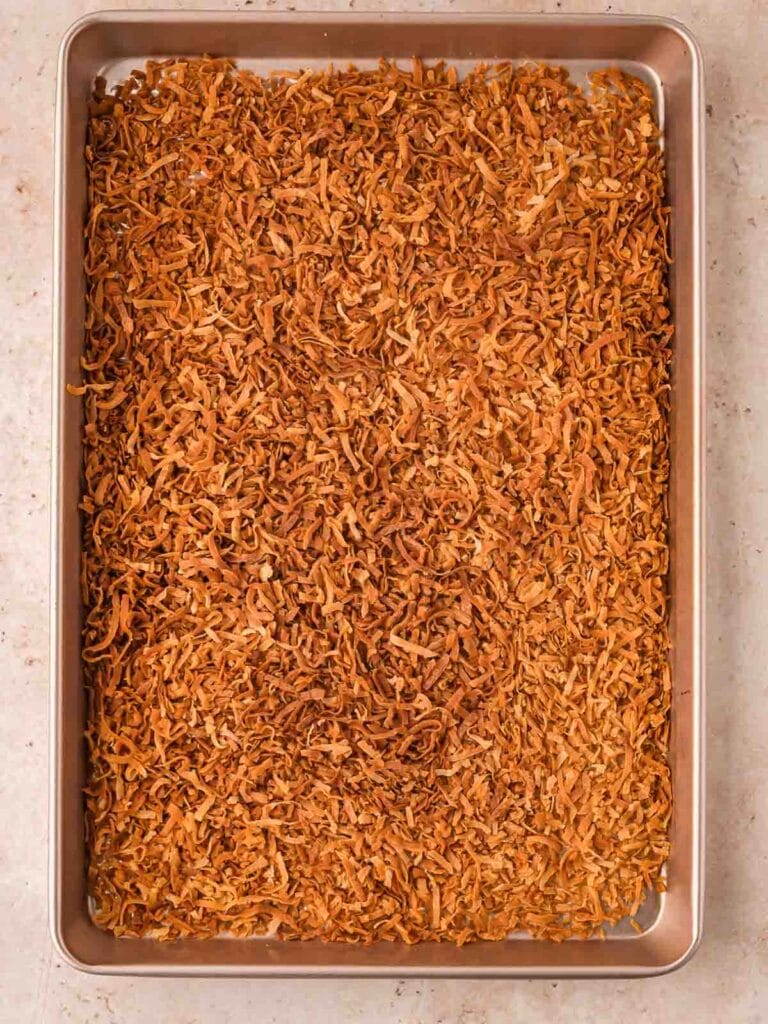 Toasted coconut in a baking pan.