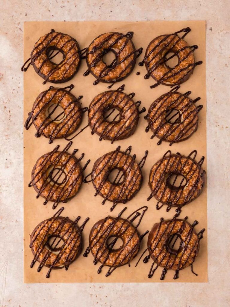 Chocolate drizzled on top of the samoas cookies.