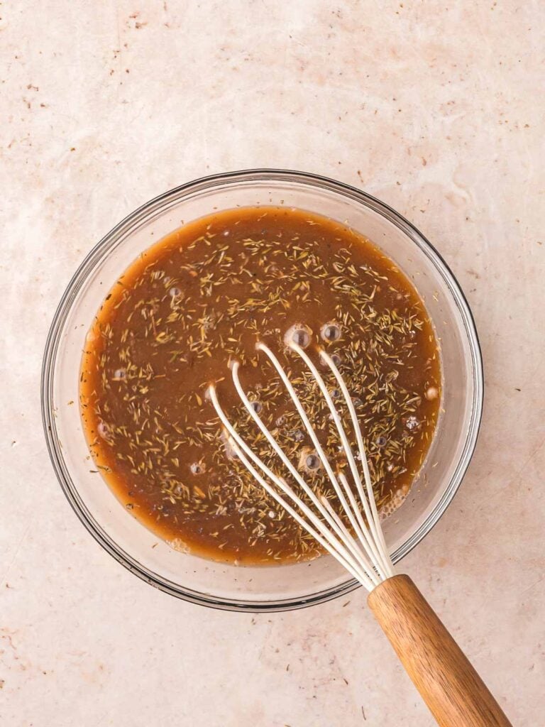 Soup mixes in a bowl with a whisk.