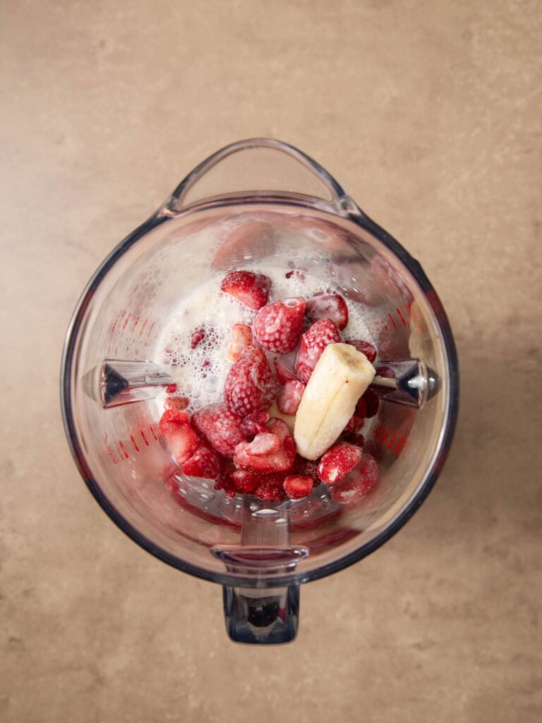 All the ingredients for a Smoothie Bowl in a blender.