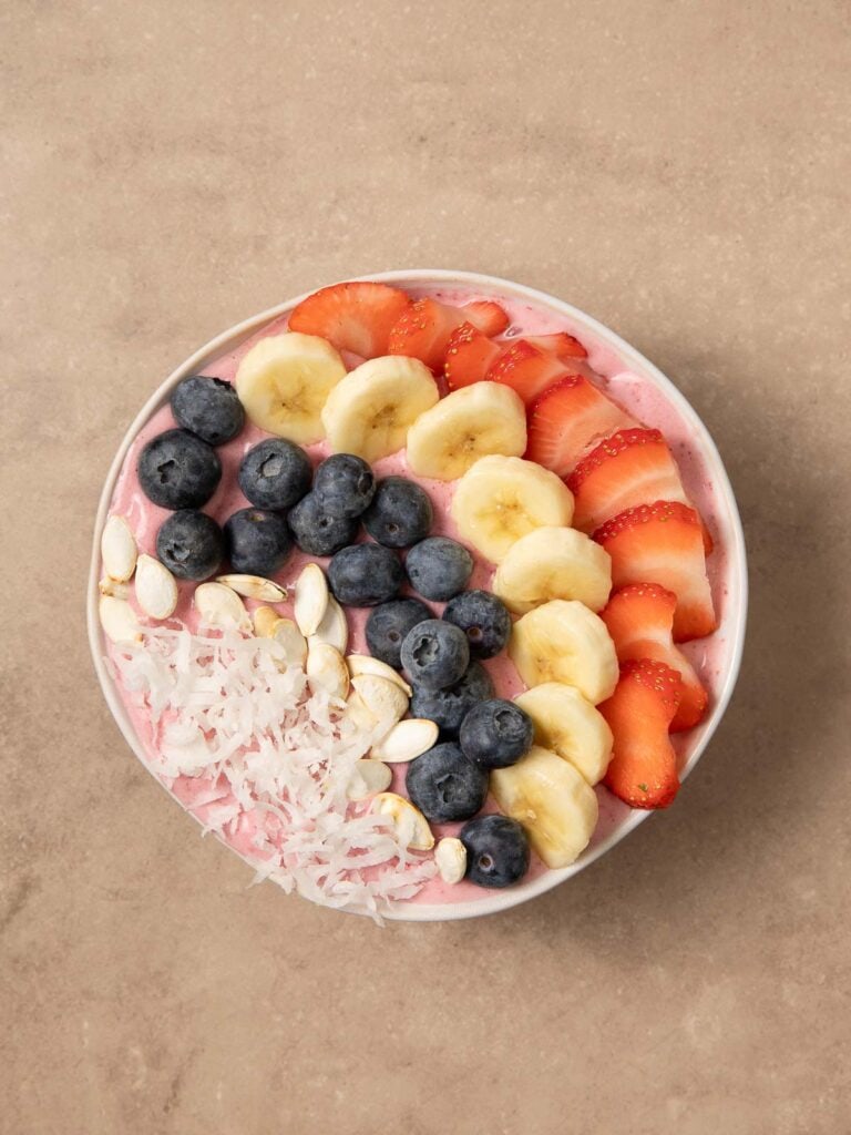 All the toppings on top of the blended smoothie bowl.