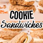 A stack of carrot cake cookie sandwiches filled with rich cream cheese frosting. The front cookie has a bite taken out, revealing the soft texture inside. Freshly shredded carrots and pecans are scattered around.