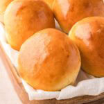 Brioche Buns in a wooden basket.