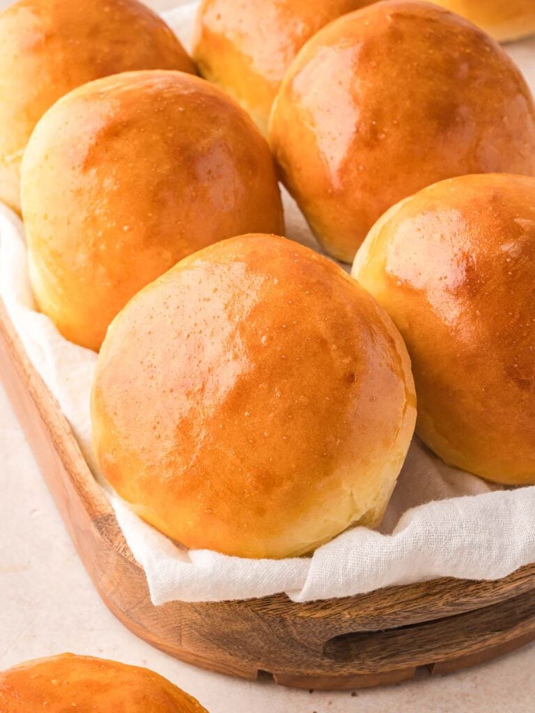 Brioche Buns in a wooden basket.