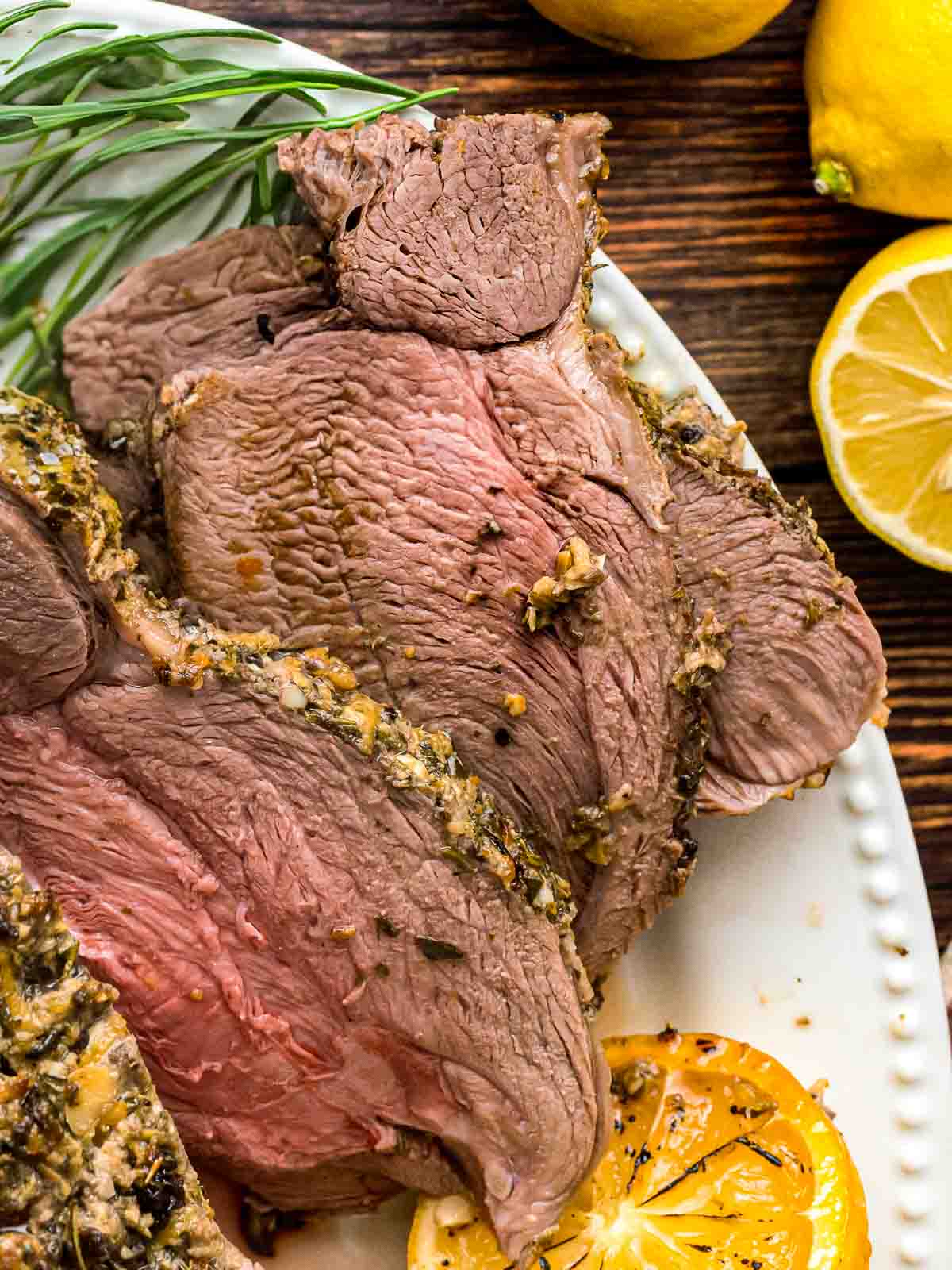 Slices of roast leg of lamb on a plate.