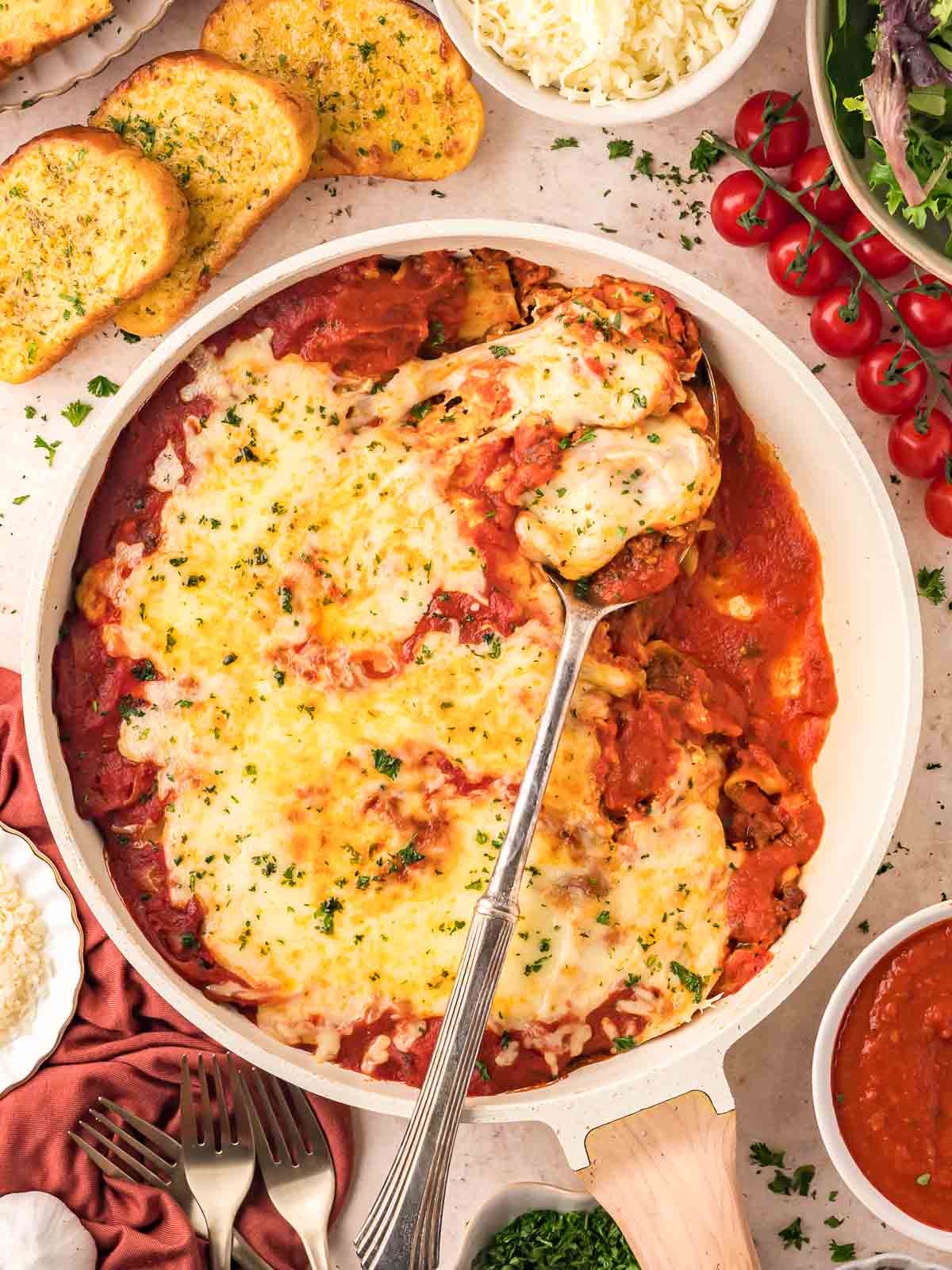 Cooked Skillet Lasagna in a pan with a spoon.