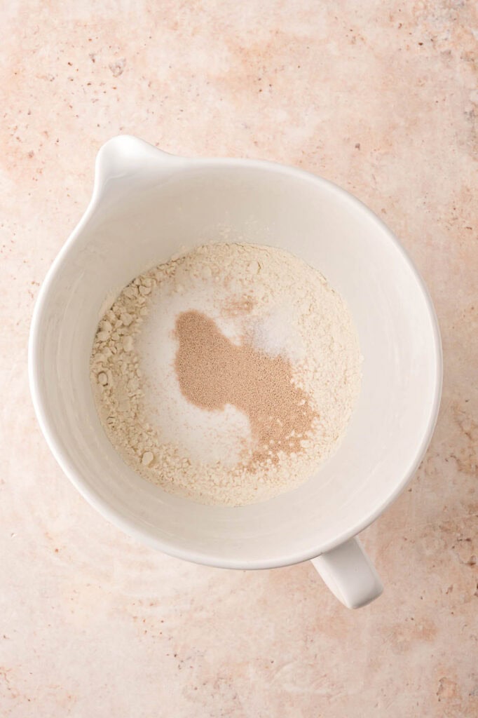 Flour, yeast, salt and sugar in a mixing bowl.