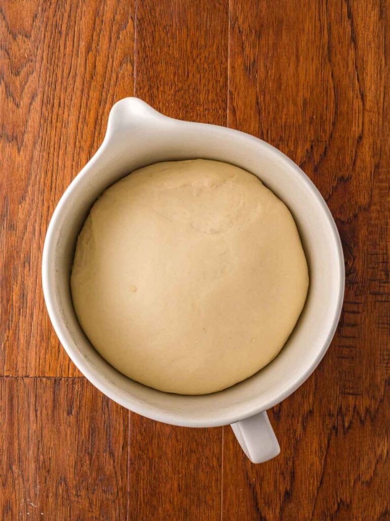 Cinnamon dough rising in a bowl.