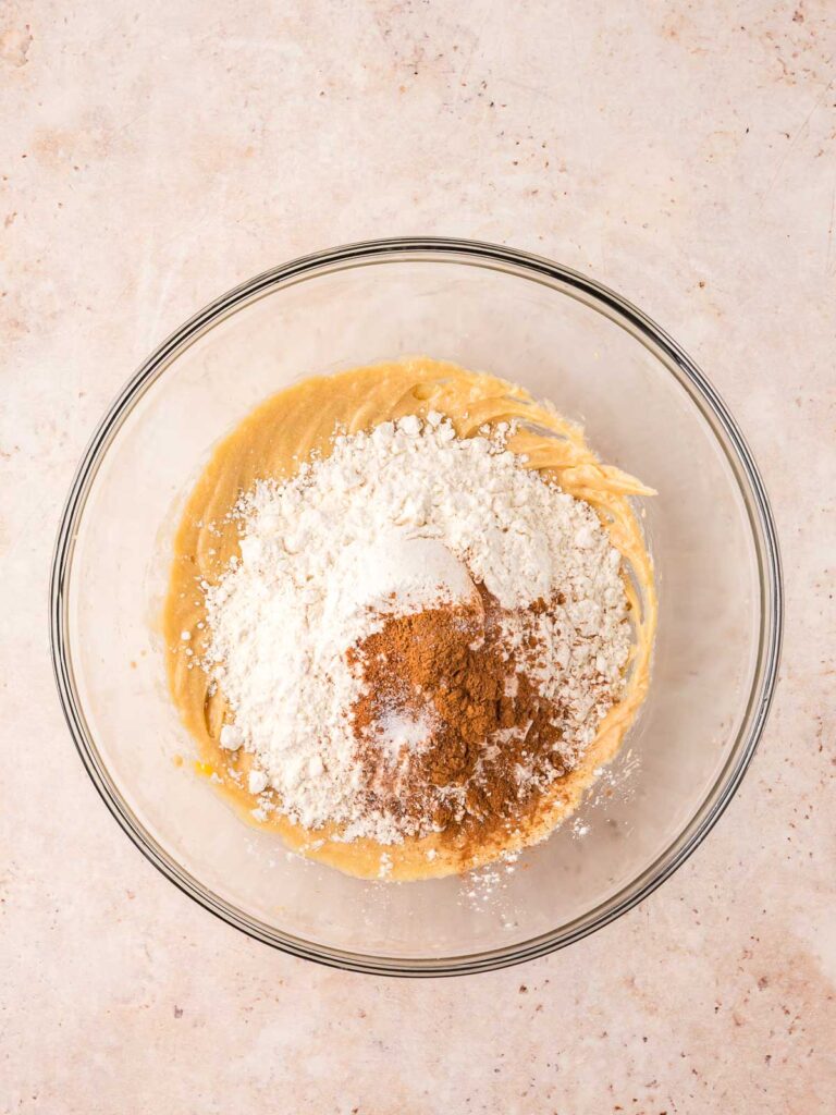 Flour and spices in a bowl with the creamed Cookie batter.