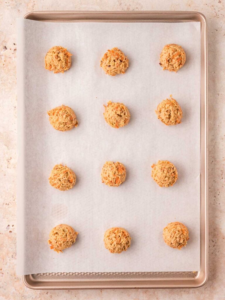 Scoops of cookie dough an a sheet pan.