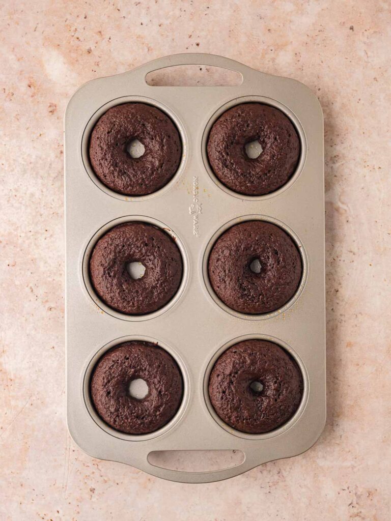 Baked double chocolate donut batter poured into a donut pan.