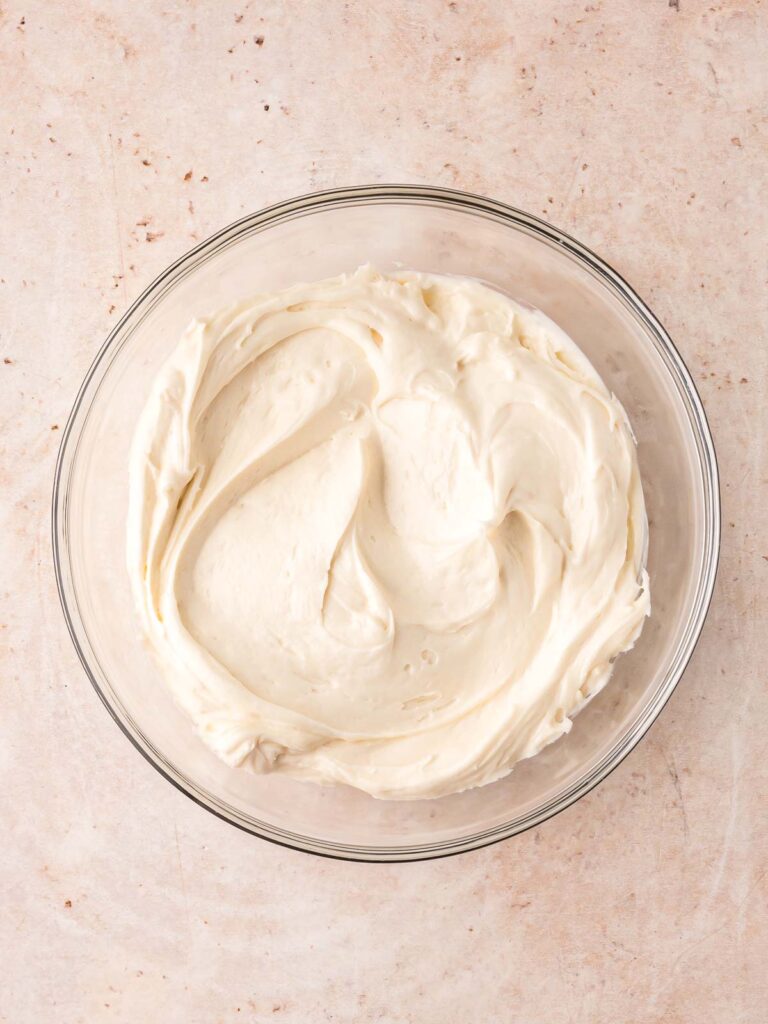 Cream cheese frosting whipped in a bowl.