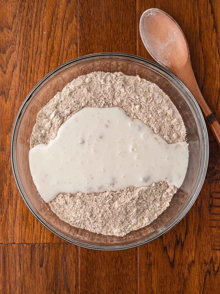 Buttermilk poured on top of the dry ingredients for irish brown bread.