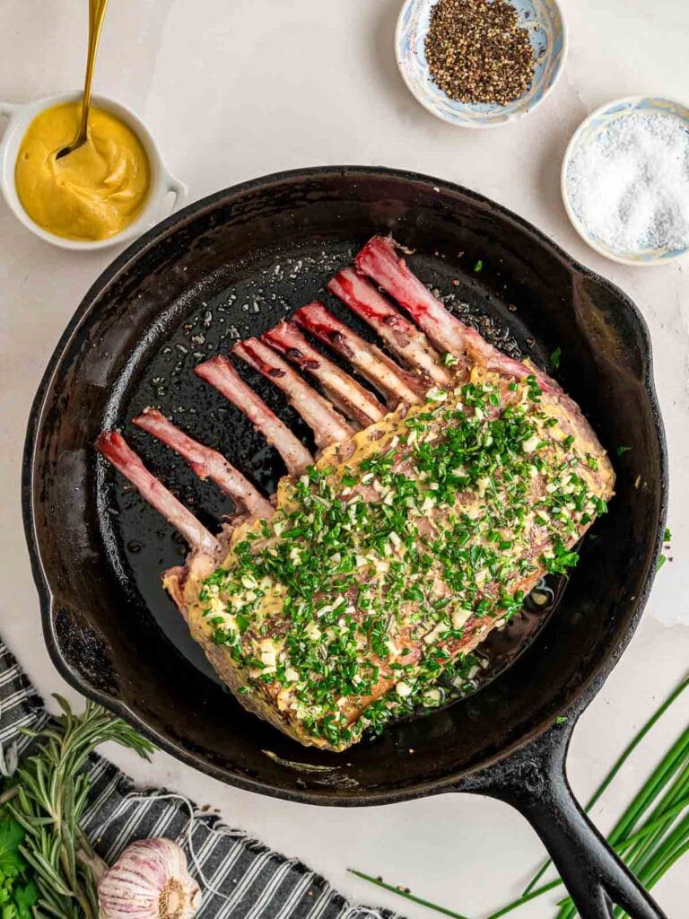 Mustard and herb mixture rubbed on to a rack of lamb.