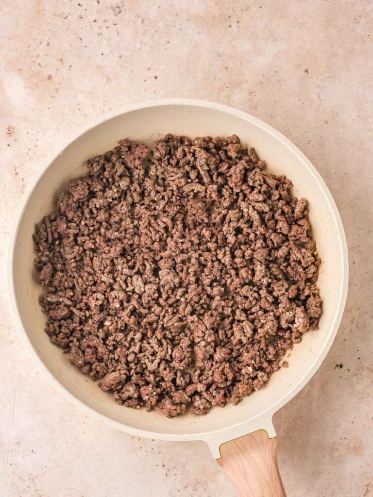 Ground beef cooked in a pan.