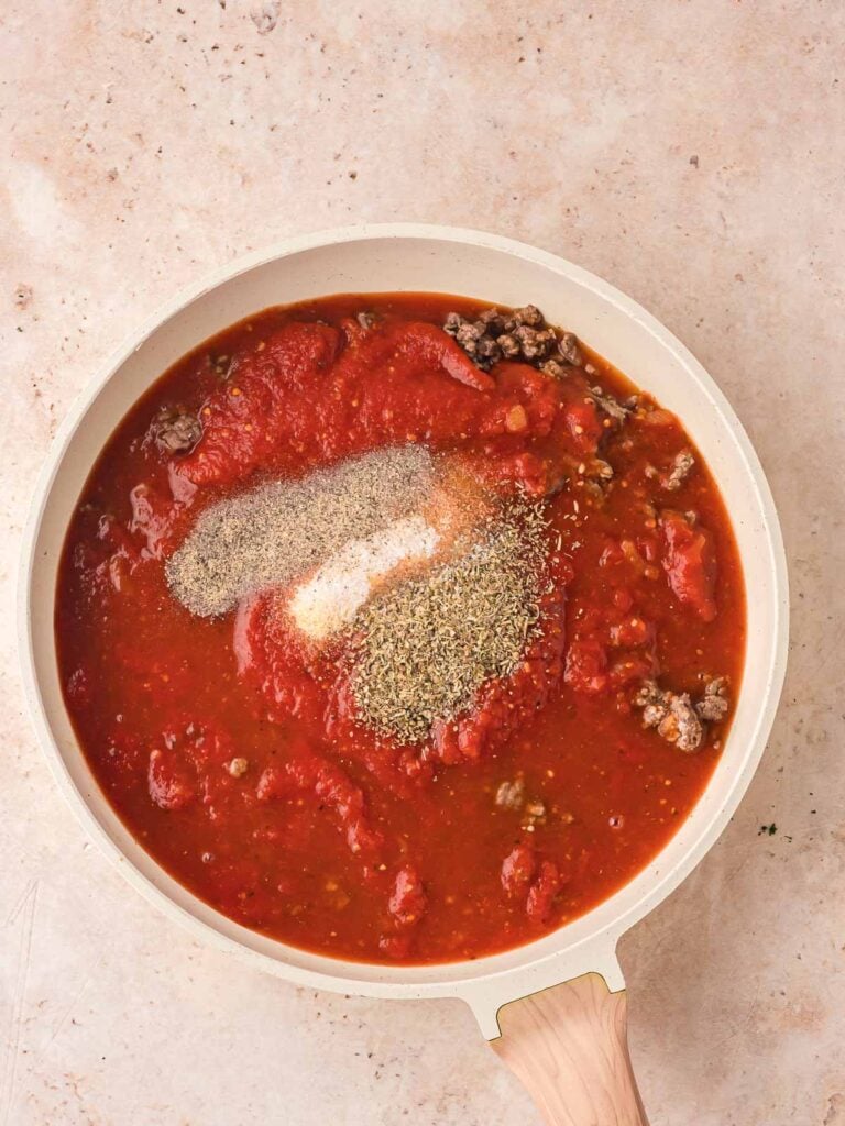 Marinara and seasoning in a pan with the ground beef.