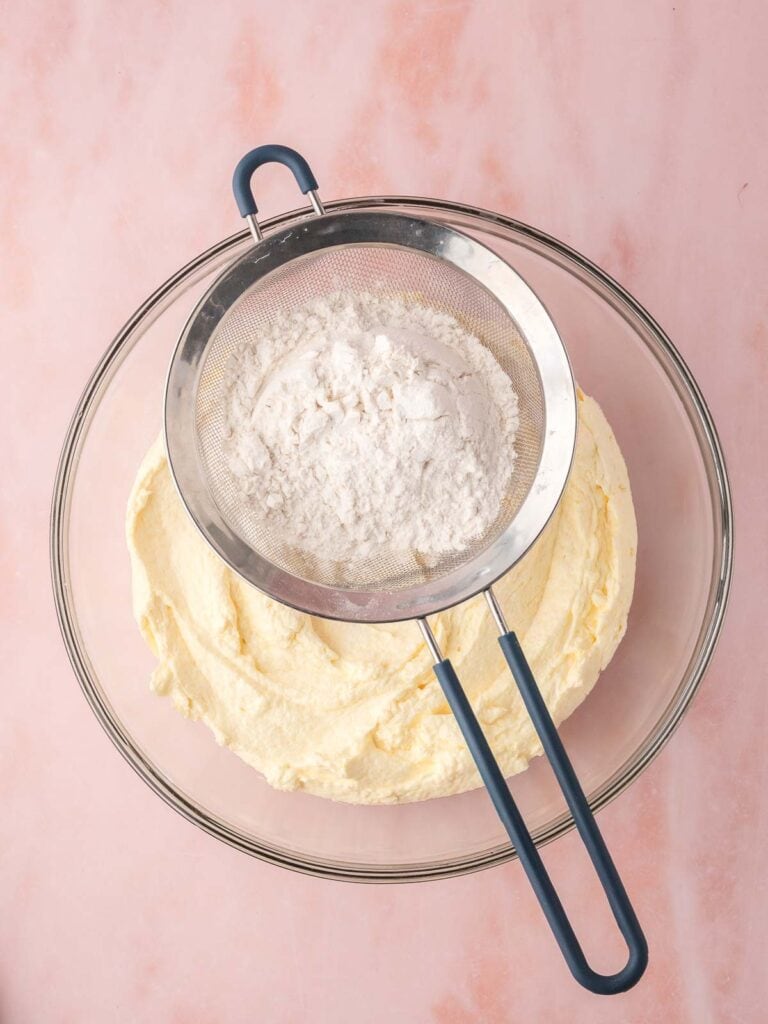 Flour being sifted into the batter.