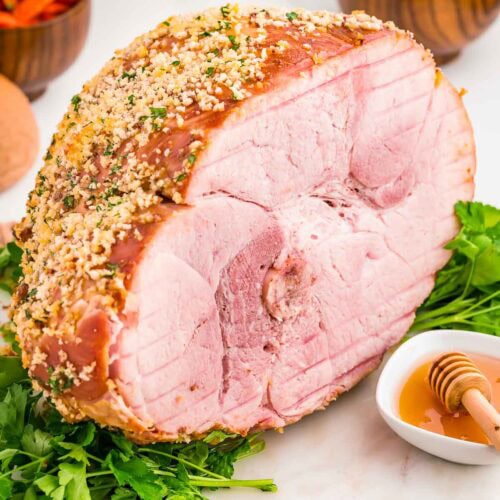 The inside of a fully cooked baked ham with a herb crust.