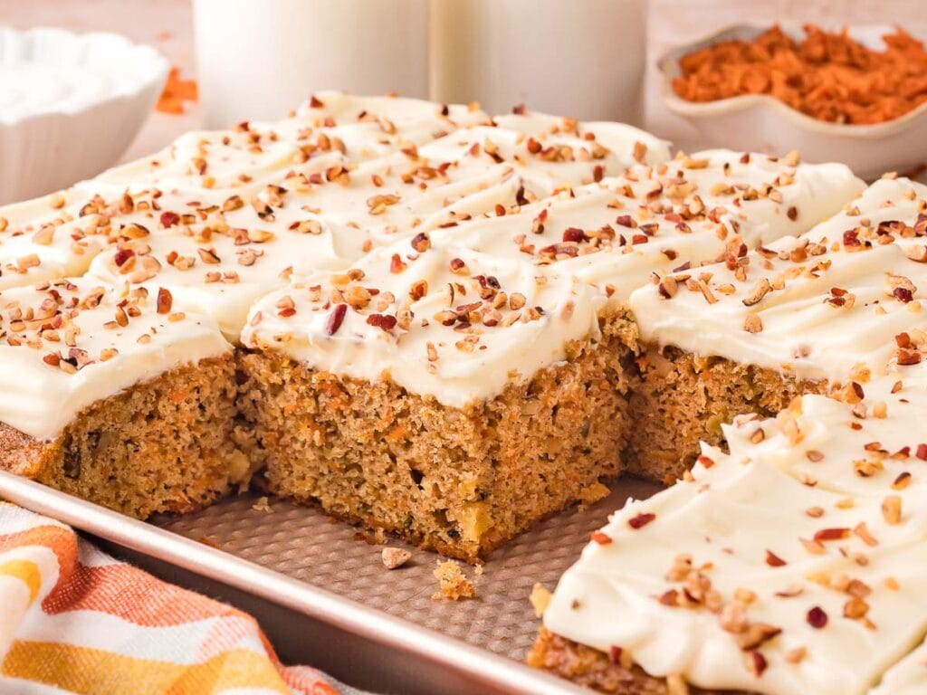 Sliced of carrot cake sheet in a sheet pan.