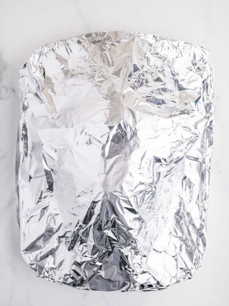 Baked Ham covered in foil.