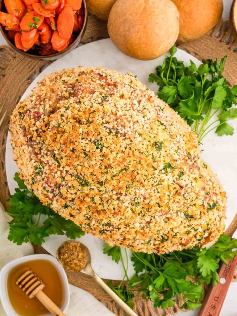 Herb Crusted Baked Ham on a serving plate.