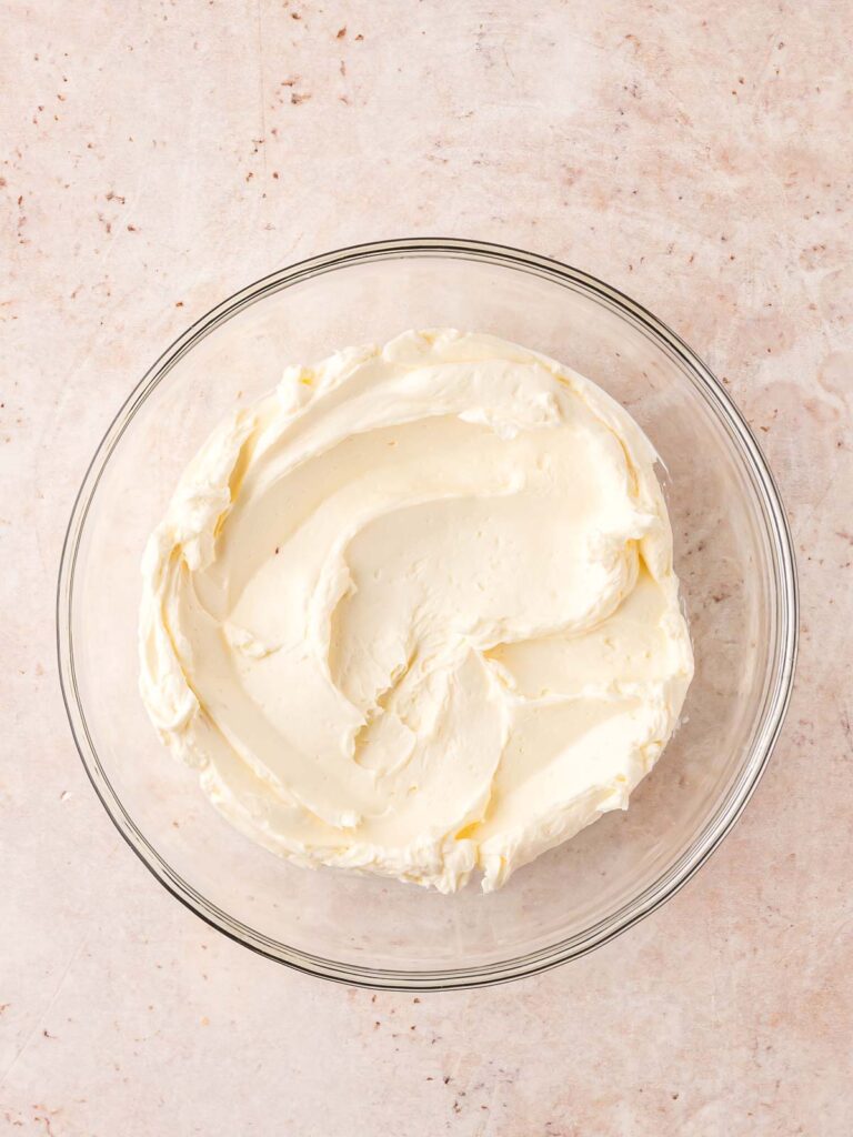 All the cream cheese frosting mixed together in a bowl.