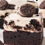Oreo cheesecake brownies with cookie layer stacked on plate.