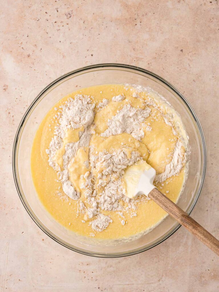 Wet and dry ingredients being gently folded together to make muffin batter.