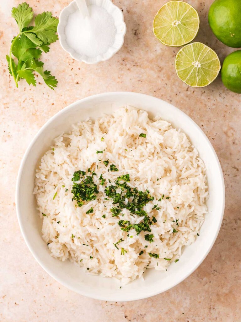 Bowl of cilantro-lime rice topped with chopped fresh cilantro.