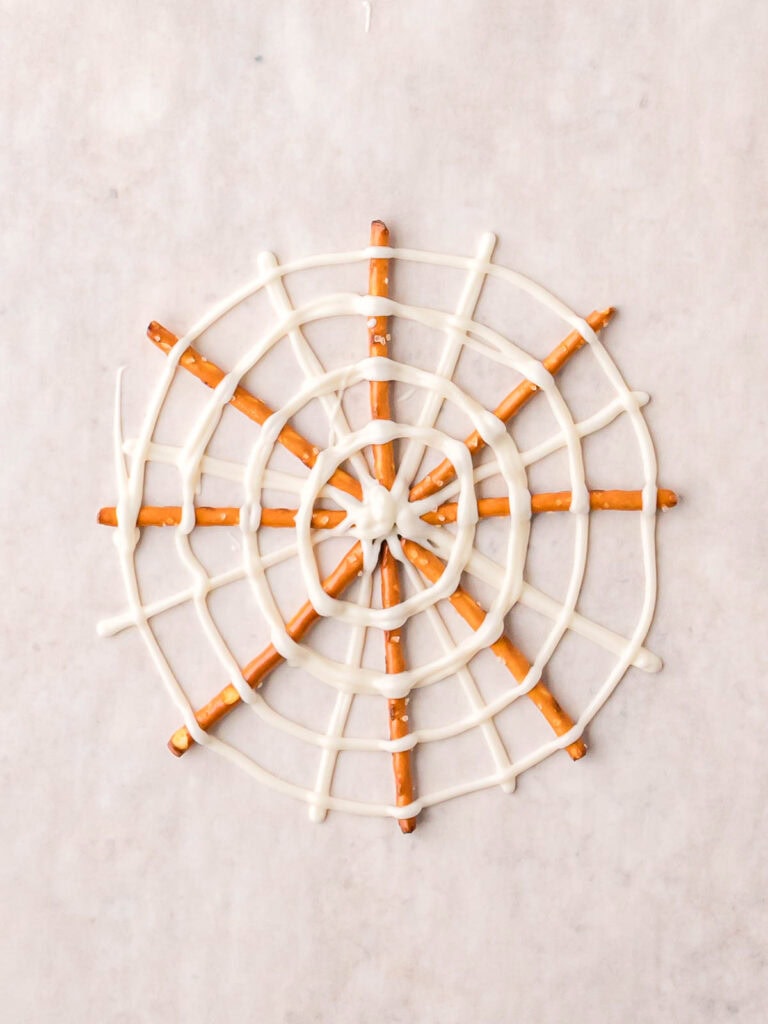 Pretzel Spider Web made with pretzels and white chocolate spiral before adding candy decorations.