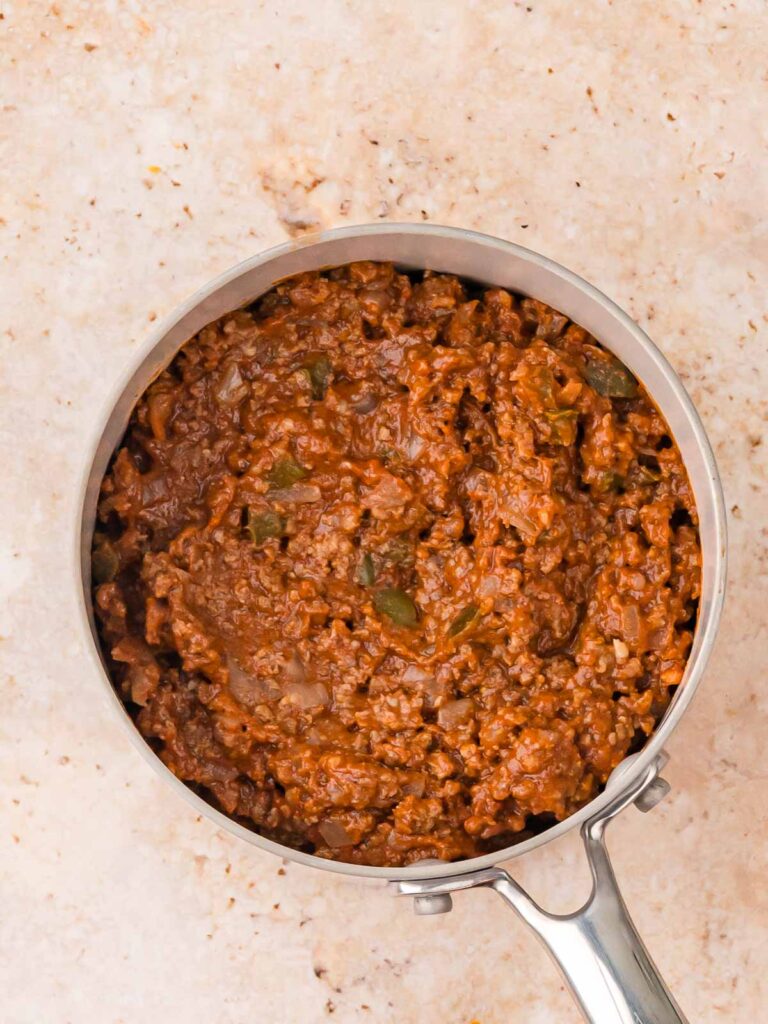 Homemade sloppy joe mixture in a silver saucepan.
