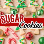 Decorated Christmas tree sugar cookies with colorful icing and ornaments on a holiday tray.