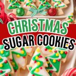 Decorated Christmas tree sugar cookies with colorful icing and ornaments on a holiday tray.