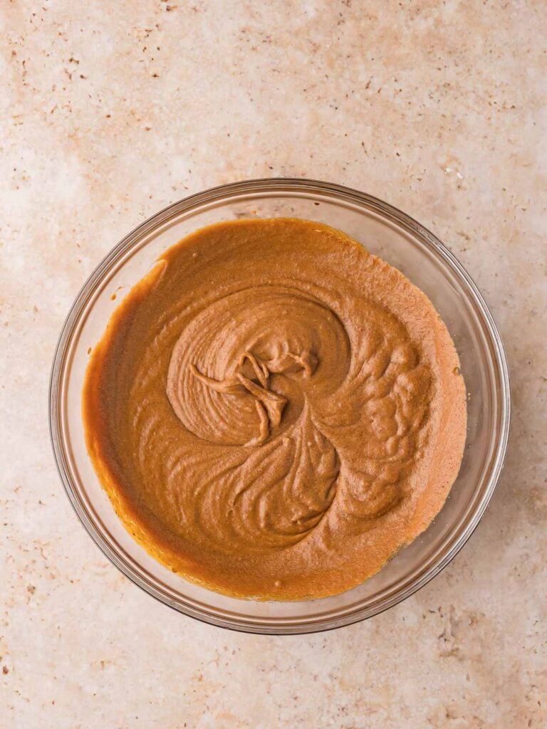 Wet ingredients mixed together for Gingerbread Cake batter showing a smooth caramel color.