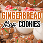 Close-up of a smiling Gingerbread Man Cookie with red bow tie and green buttons, surrounded by festive holiday treats.