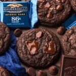 Double Chocolate Chunk Cookies made with Ghirardelli dark chocolate, surrounded by chocolate squares and chips.