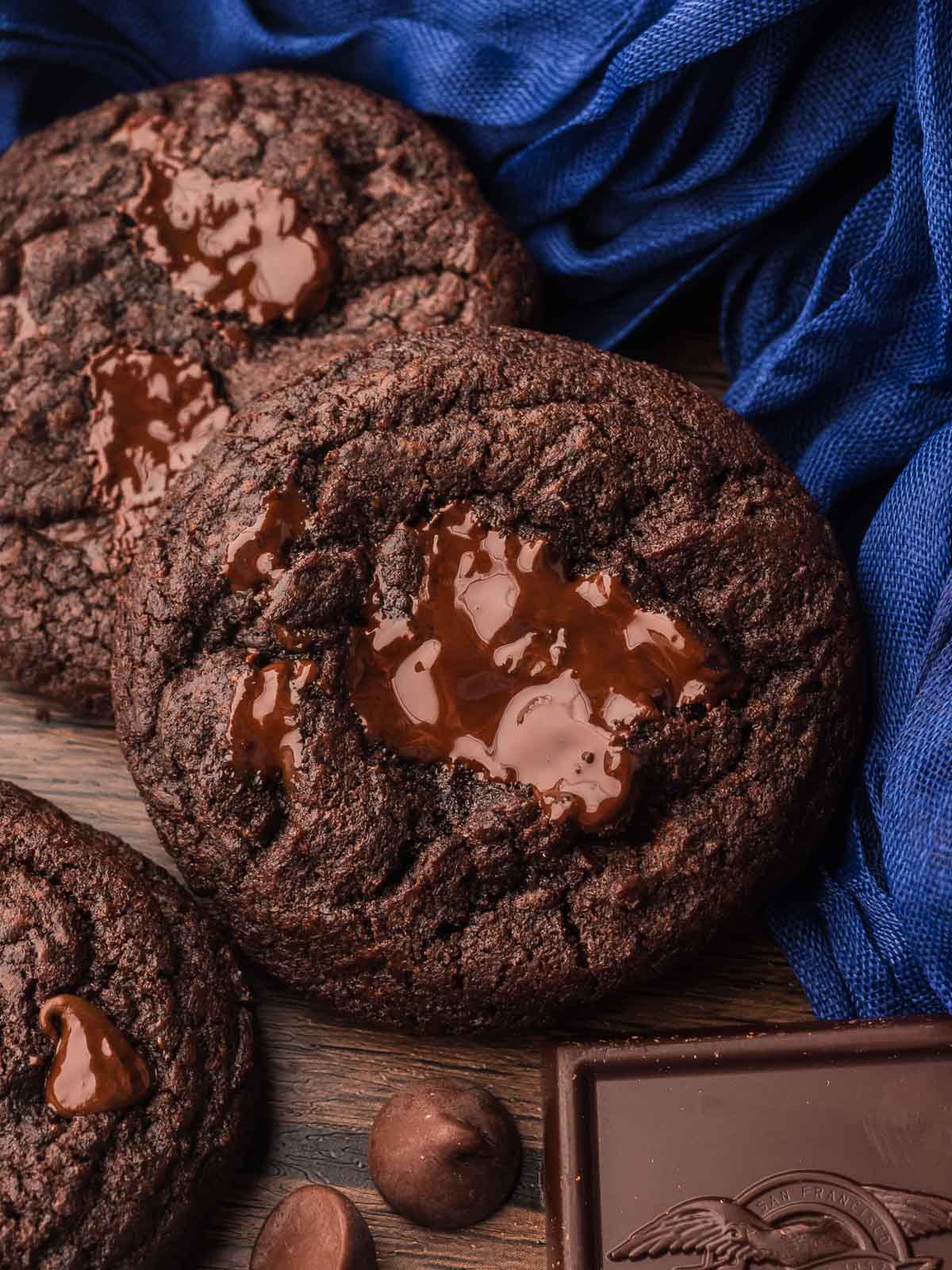 Soft and chewy Double Chocolate Chunk Cookies with glossy melted chocolate centers and dark chocolate pieces.