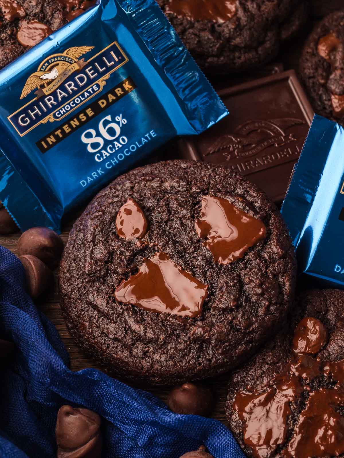 Double Chocolate Chunk Cookies featuring Ghirardelli dark chocolate bars and chips, styled with blue napkins.