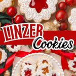 Linzer cookies with jam centers and powdered sugar on top, arranged with Christmas decorations and red ribbon.