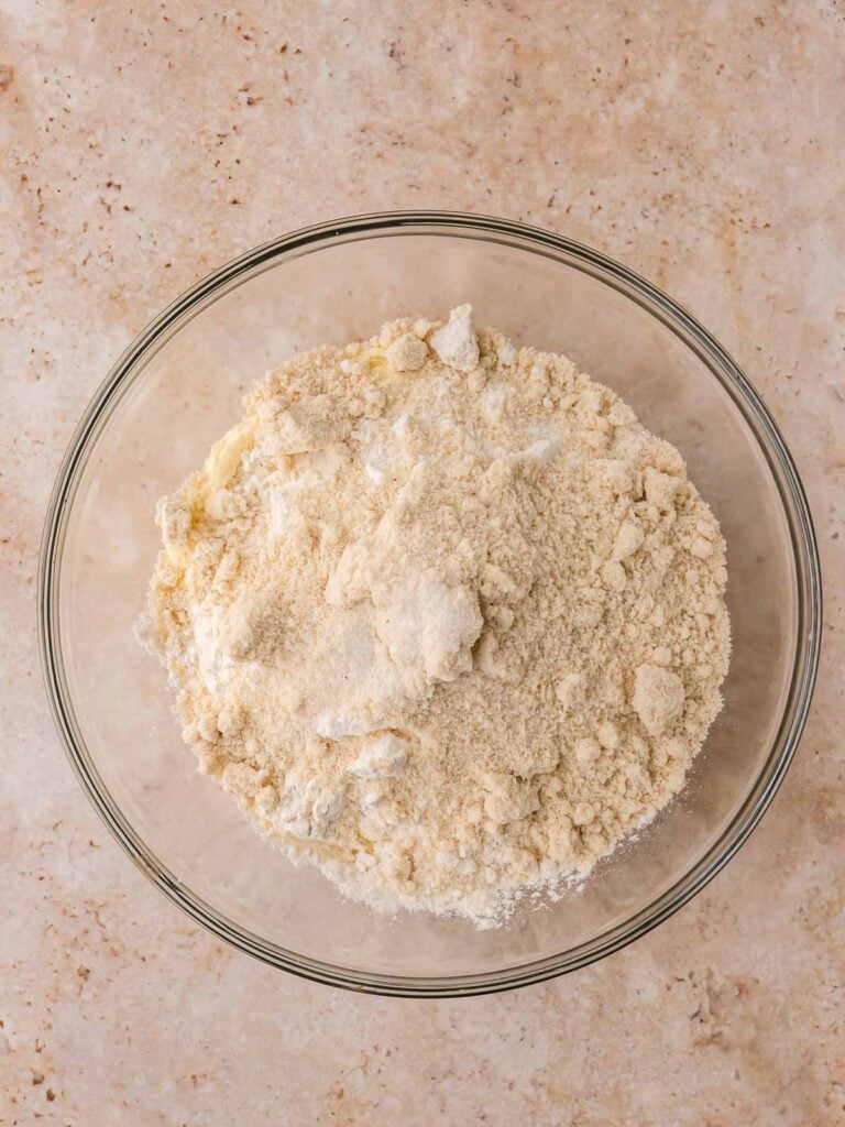 Flour, almond flour, and salt combined with wet ingredients to form Linzer cookie dough.