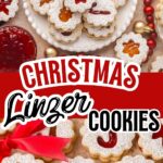 Linzer cookies with jam filling and powdered sugar ona serving dish with christmas decorations all around them.